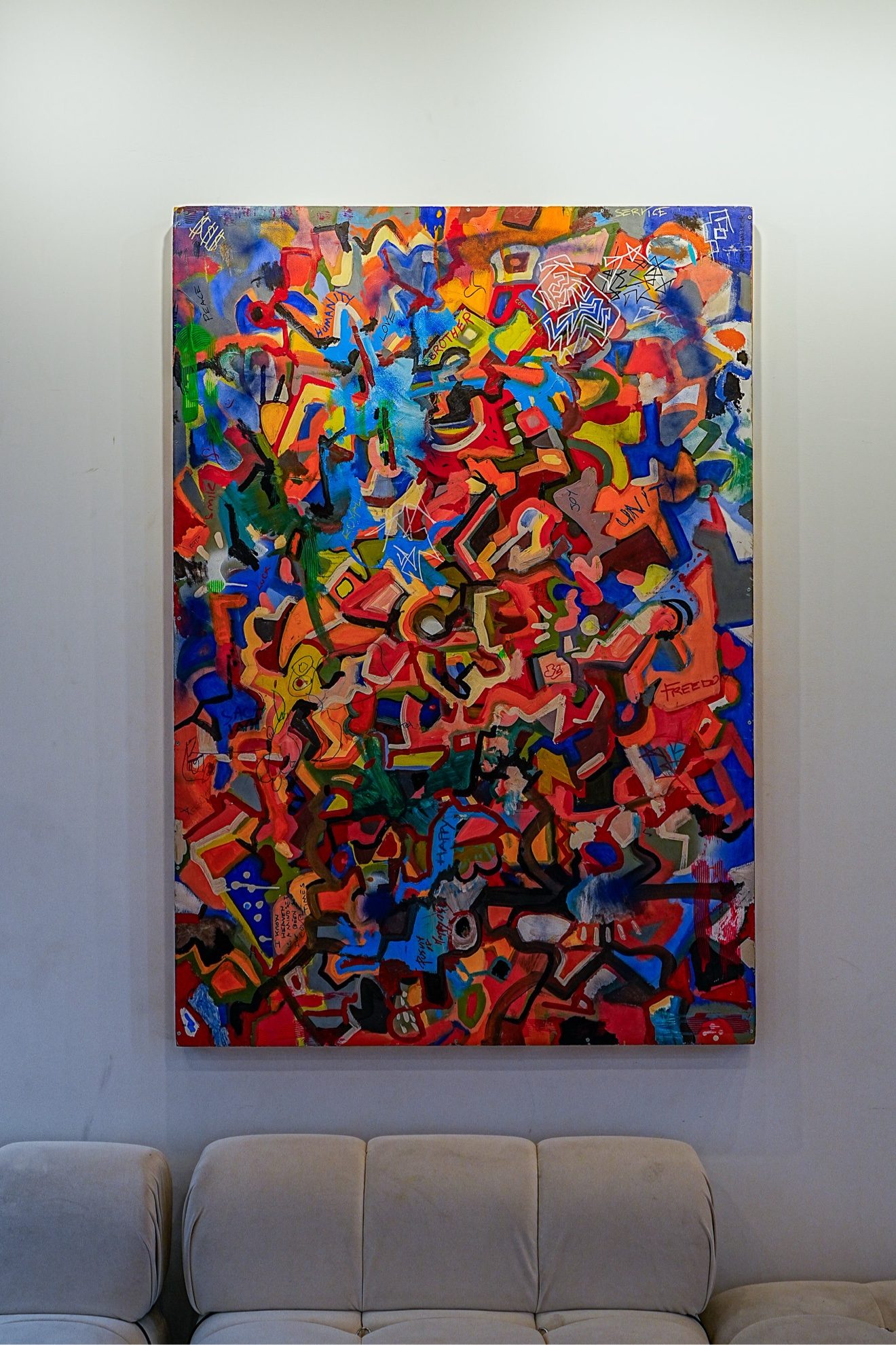 Large colorful abstract painting above the lounge sofa